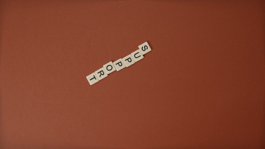 Letter tiles spelling 'Support' on a brown background with ample copy space.