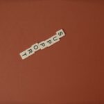 Letter tiles spelling 'Support' on a brown background with ample copy space.