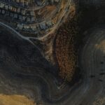 Stunning aerial view capturing residential and rugged natural landscape in Tekoa.
