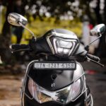 Front view of a black motorbike parked on a street in Chennai, India.