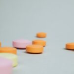 Close-up of colorful round tablets arranged randomly on a neutral surface.