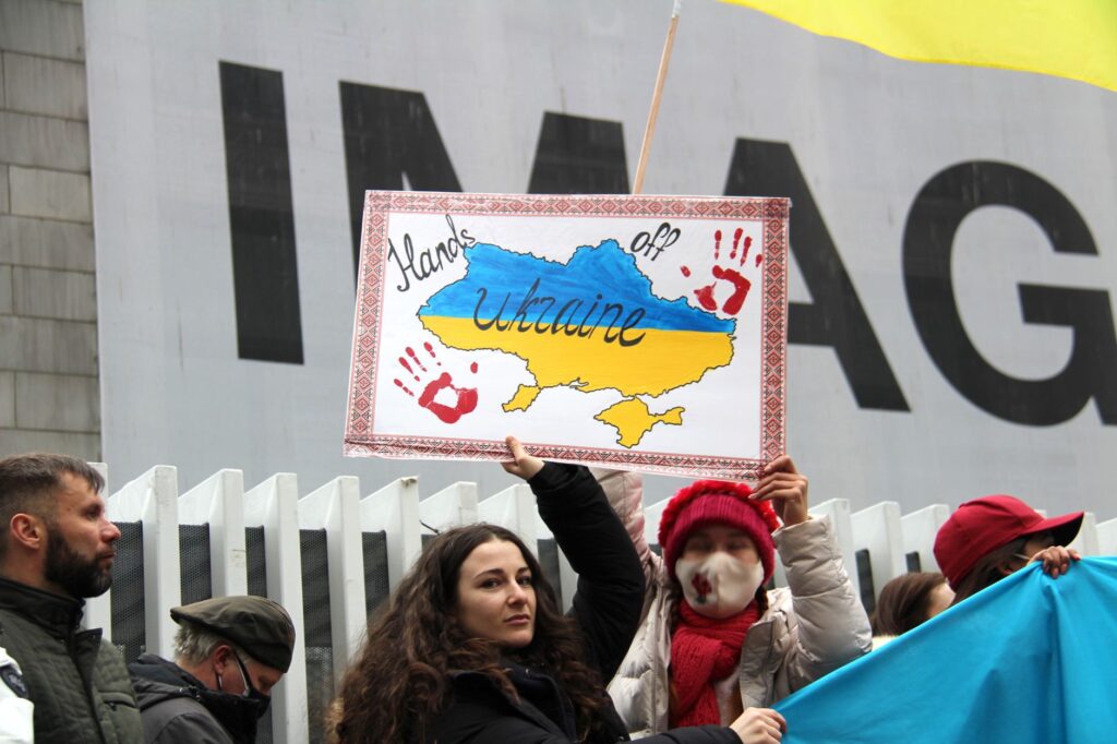 Demonstrators rally for Ukraine in Vancouver, holding signs and flags during a peaceful protest.