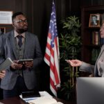 Diverse group of lawyers in a serious office meeting discussing legal matters.