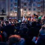 Crowd gathered peacefully in Vilnius with flags supporting Ukraine, urging for peace and unity.