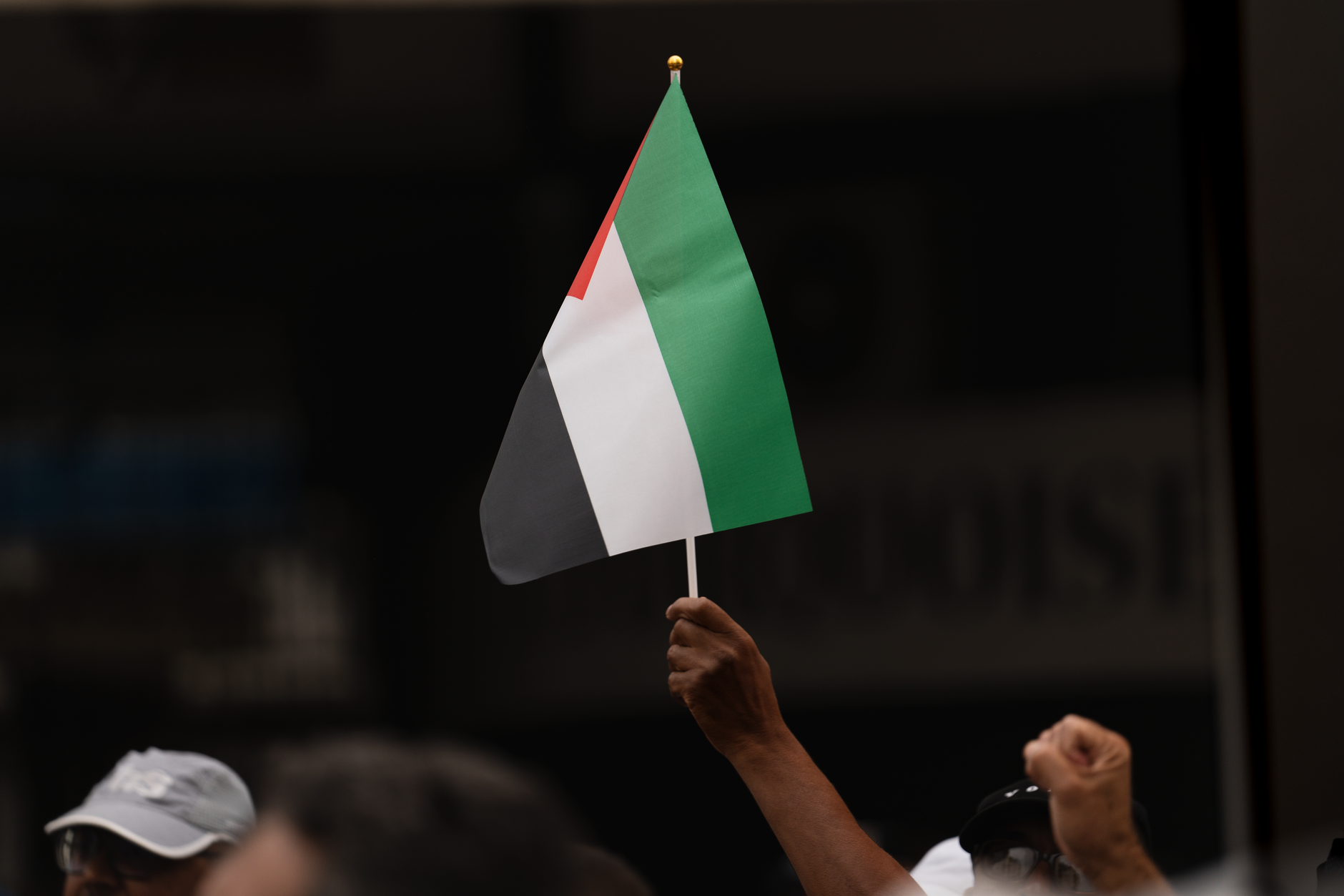 Close-up of a hand holding a Palestinian flag during protest in Rabat, Morocco.