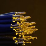 Detailed view of blue ethernet cables with exposed gold-plated conductors.