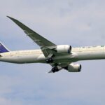 Saudia Airlines Boeing 787 aircraft captured during flight with clear sky background.