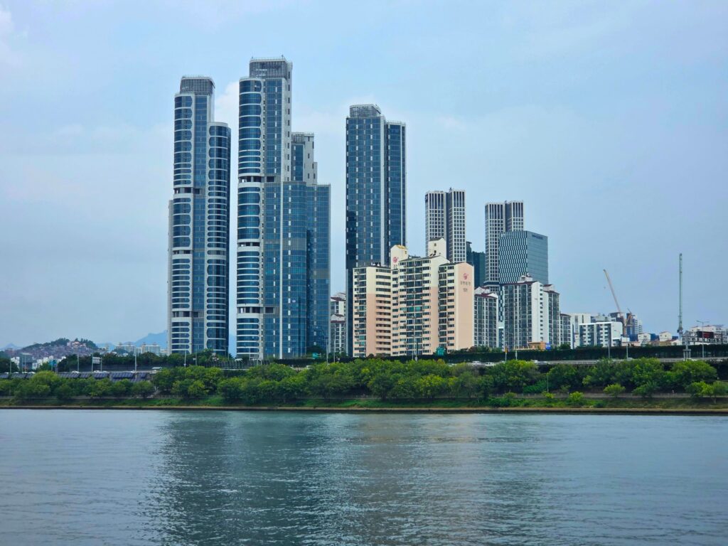 Panoramic view of modern skyscrapers in Seoul, South Korea with waterfront.