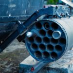 Detailed view of a military rocket launcher showcased outdoors, showcasing industrial design.