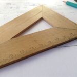 Close-up of a wooden ruler on paper, ideal for educational themes and measuring concepts.