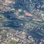 Stunning aerial view showcasing a city with a river running through urban landscapes.