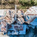 Aerial view of abandoned, rusty industrial containers in Fulton, MO, showcasing decay and industry.