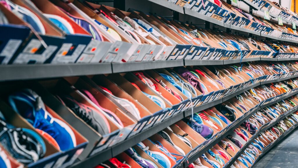 A vibrant display of various sneakers on shelves in a shoe store, showcasing styles and options.