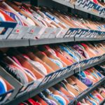 A vibrant display of various sneakers on shelves in a shoe store, showcasing styles and options.