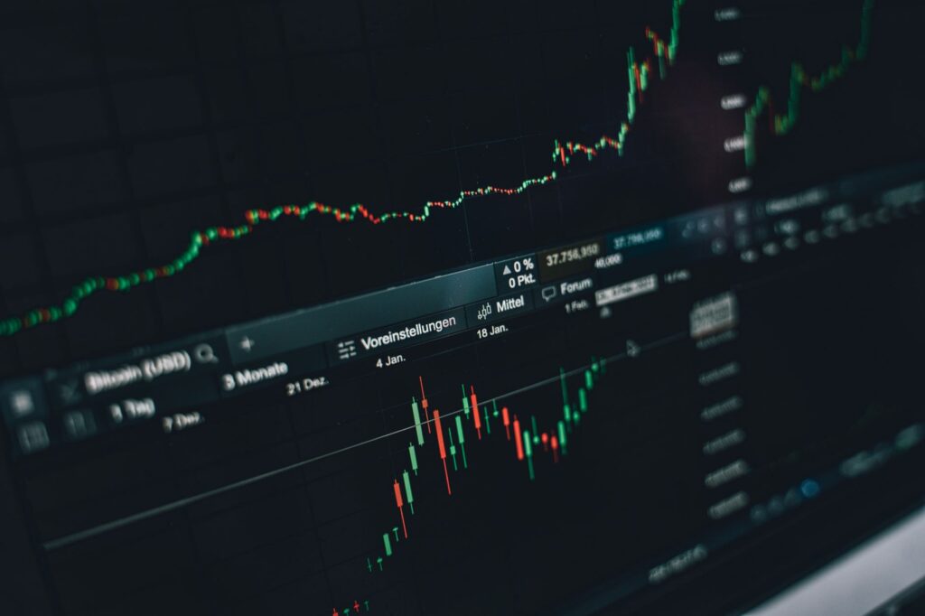 Close-up of a digital market analysis display showing Bitcoin and cryptocurrency price trends.