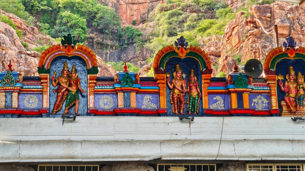 Colorful sculptures on a Hindu temple facade in Tirupati, India, showcasing intricate craftsmanship and religious symbolism.