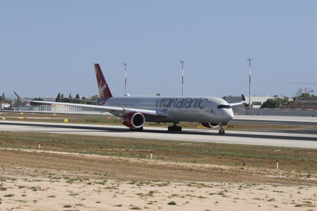 Virgin Atlantic airplane captured on runway during daytime, showcasing aviation and travel.
