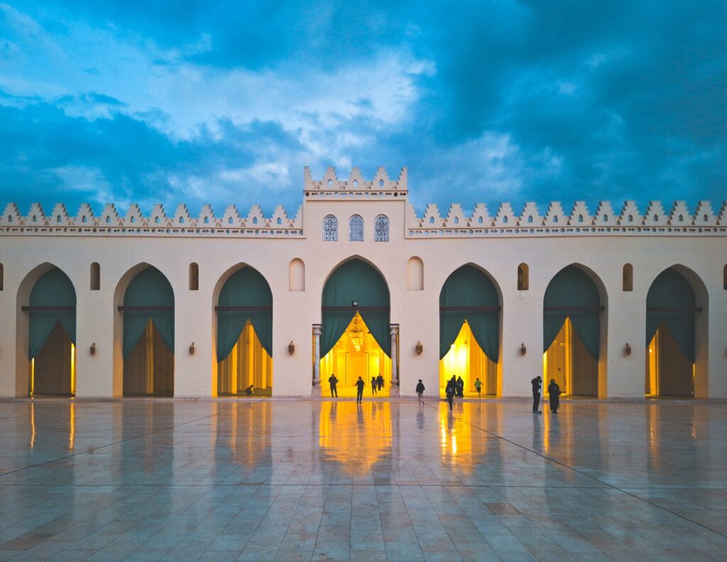 Stunning view of Al-Hakim Mosque during blue hour in Cairo, showcasing illuminated architecture.