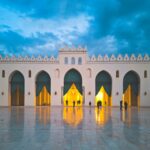 Stunning view of Al-Hakim Mosque during blue hour in Cairo, showcasing illuminated architecture.