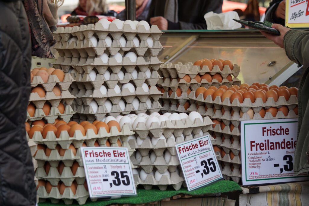 Stacks of fresh eggs in trays on sale at a traditional market in Frankfurt.