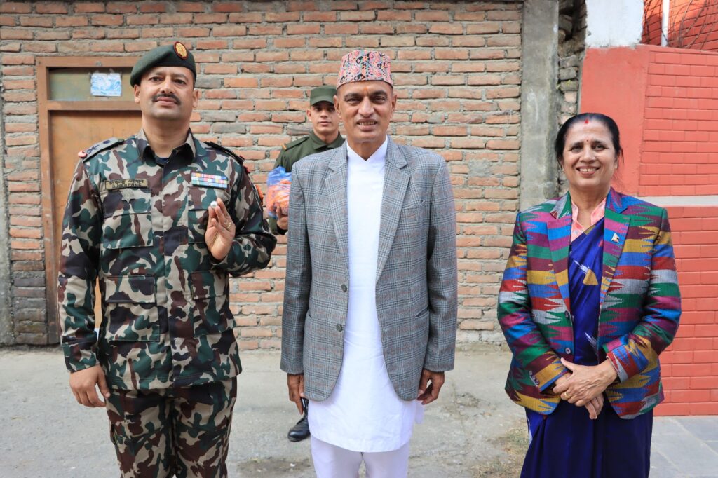 Three adults, including two men and one woman, standing together outdoors in formal attire.