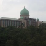 Scenic view of Malaysia's Prime Minister's Office in Putrajaya surrounded by lush greenery.