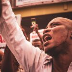 An engaged protestor shouting during a street demonstration, highlighting activism.