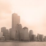 Sepia-toned view of New York City skyline with the Twin Towers on a foggy day.