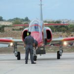 Ground crew member marshaling a jet at Malta's Luqa Airport.