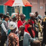 A lively street gathering in Accra, showcasing colorful traditional attire.