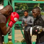 Intense outdoor boxing practice with athletes training in Abuja, Nigeria.