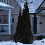 Charming Toronto house covered in snow during a serene Canadian winter day.