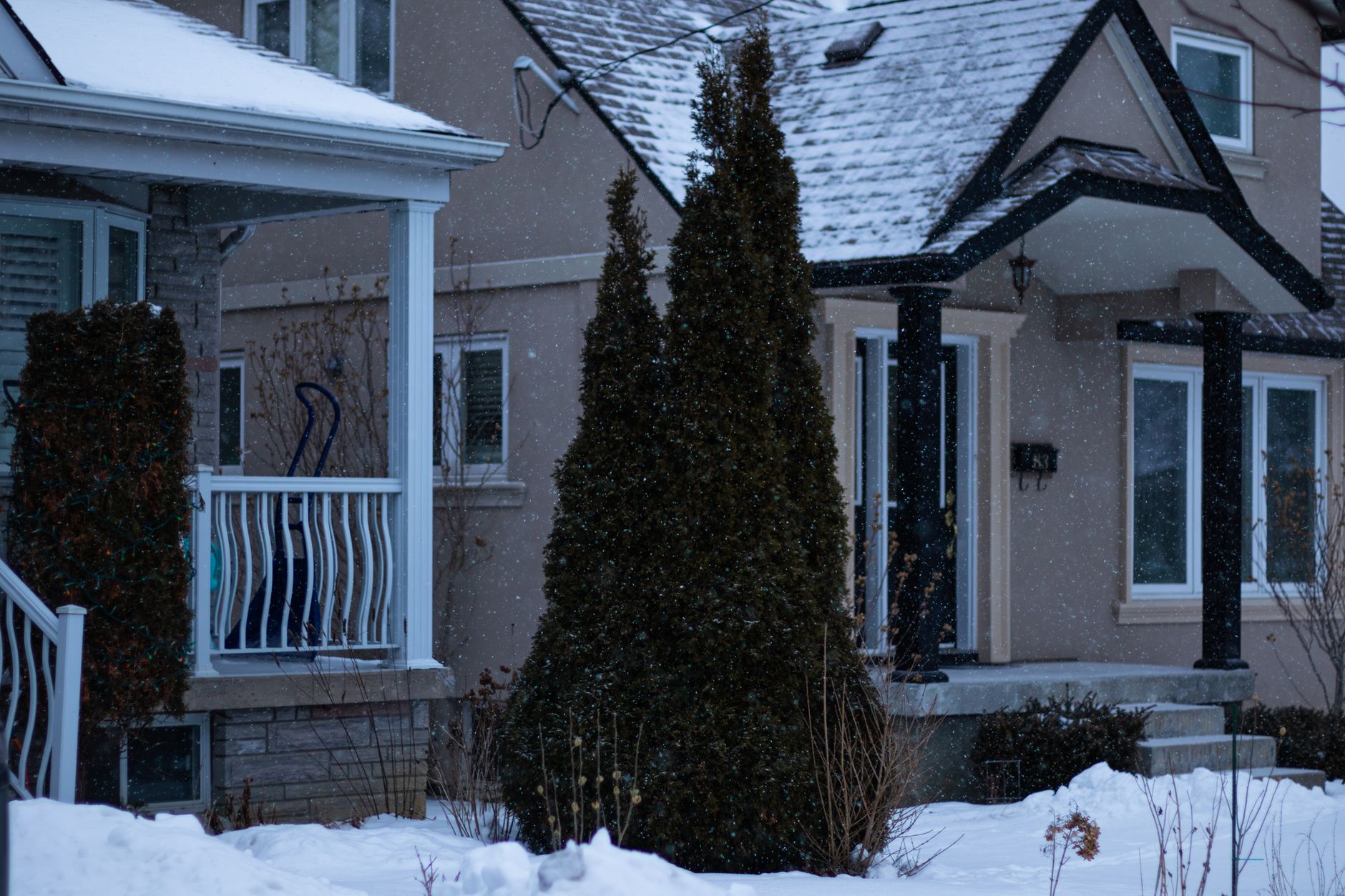 Charming Toronto house covered in snow during a serene Canadian winter day.