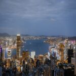 A breathtaking view of Hong Kong's illuminated skyline and harbor at night.
