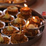 A collection of traditional Indian diyas lit and beautifully arranged for a festive occasion.