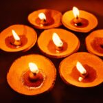 Illuminated clay oil lamps create a warm glow, ideal for festive celebrations.