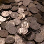 Collection of vintage Indian coins with various historical figures and details.