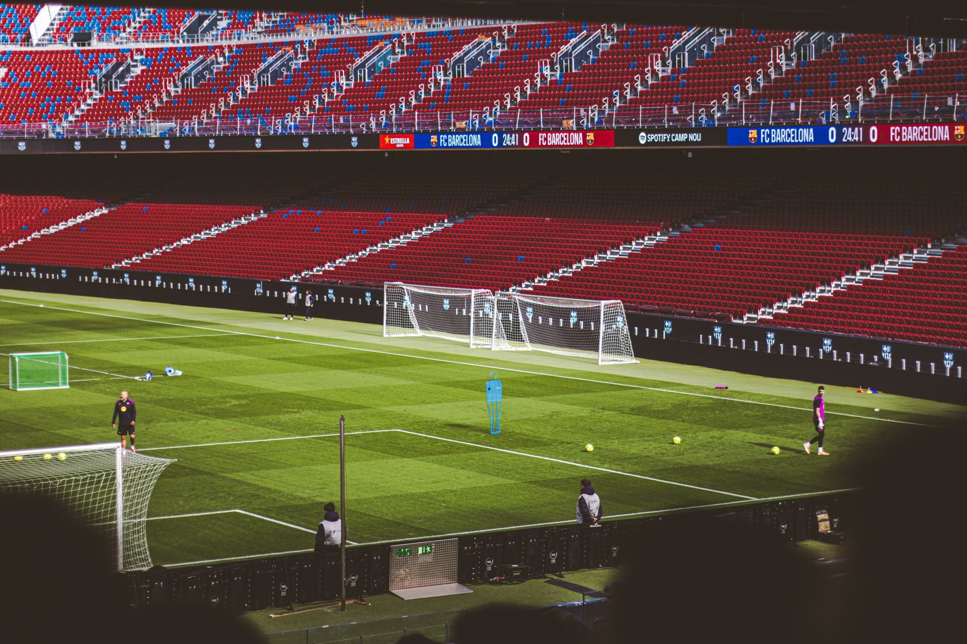 View of empty soccer field at FC Barcelona's Camp Nou with training equipment.