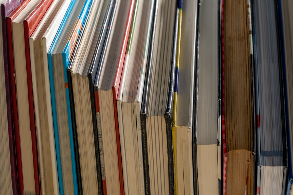 Vertical alignment of colorful book spines in a library. Ideal for study and education themes.