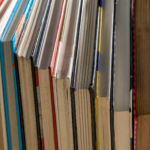 Vertical alignment of colorful book spines in a library. Ideal for study and education themes.