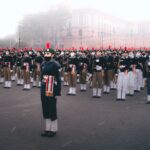 A large group of soldiers in uniform standing in formation during a military parade outdoors.