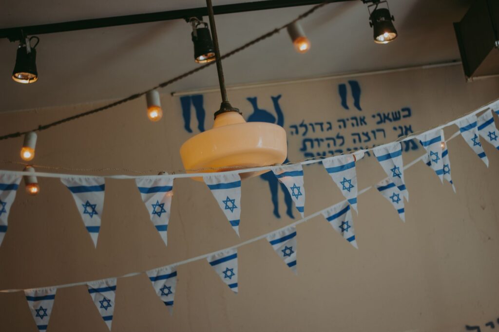 Indoor decor with Israeli flag banners and string lights creating a festive atmosphere.