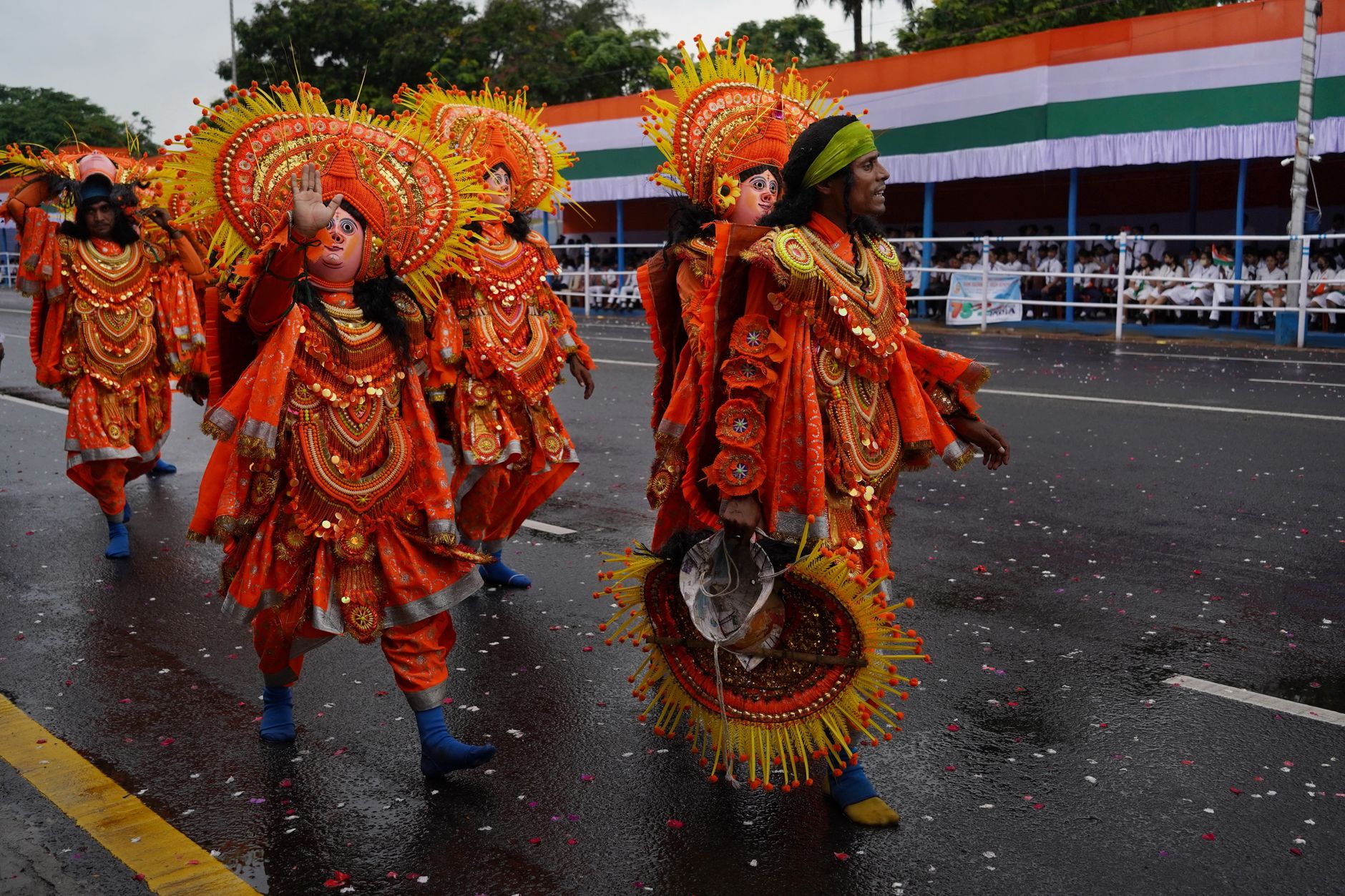 Participants in traditional costumes march during a colorful festival parade in Kolkata, India.