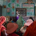 Women attending an educational session in a rural Indian classroom, promoting inclusivity and empowerment.