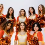 A cheerful cheerleading squad exhibiting team spirit with colorful pom poms.