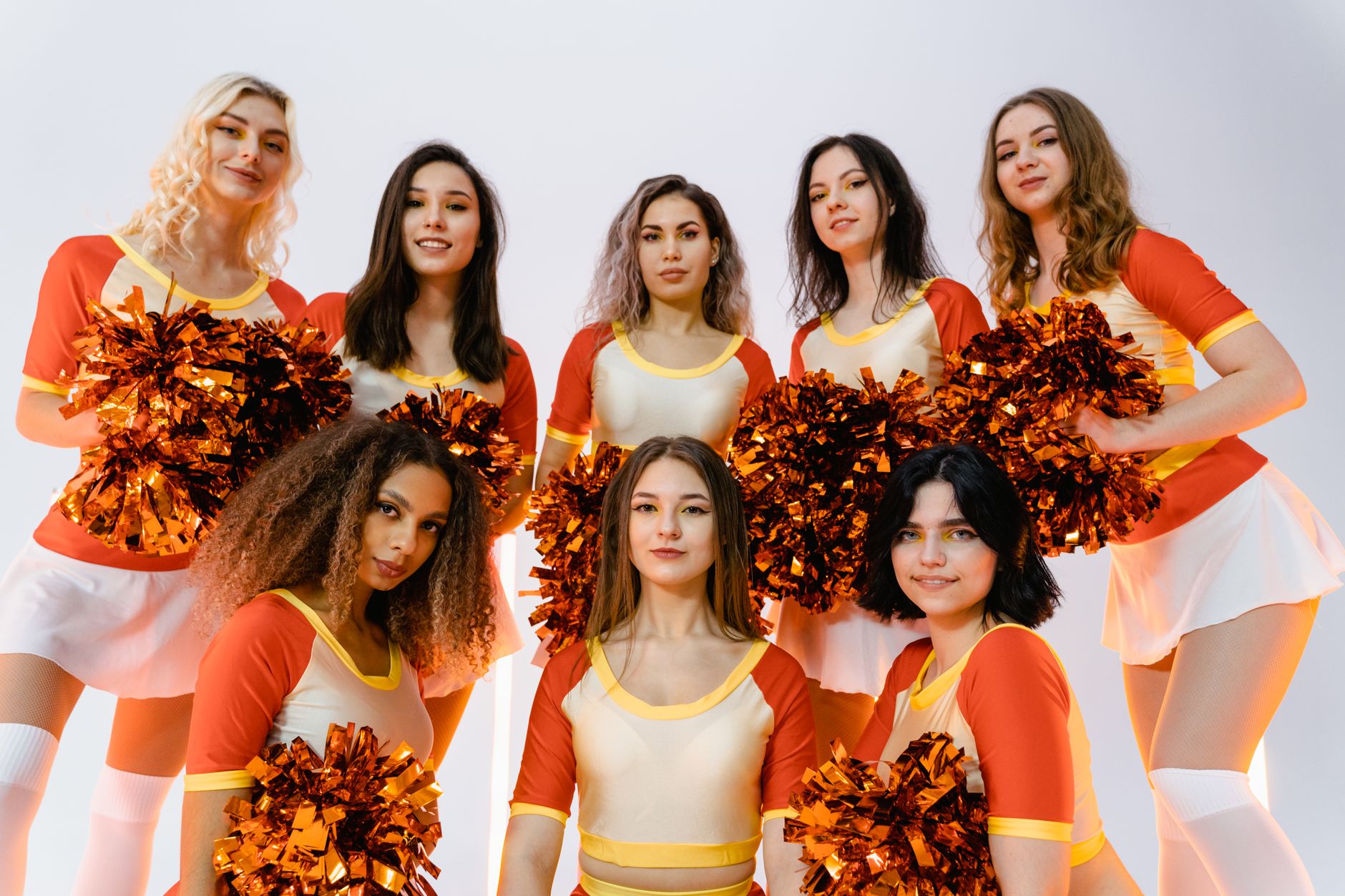 A cheerful cheerleading squad exhibiting team spirit with colorful pom poms.