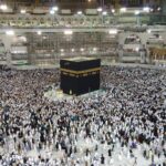 Aerial view of thousands of pilgrims gathered around the Kaaba at night in Mecca, Saudi Arabia.