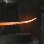 Close-up of hot iron being shaped in a forge, highlighting intense heat and craftsmanship.