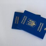 Image of two Ukrainian passports on a white surface, highlighting travel and identification themes.