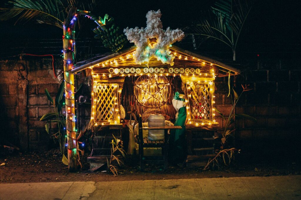 Festive Christmas decoration with lights at a school entrance during night.